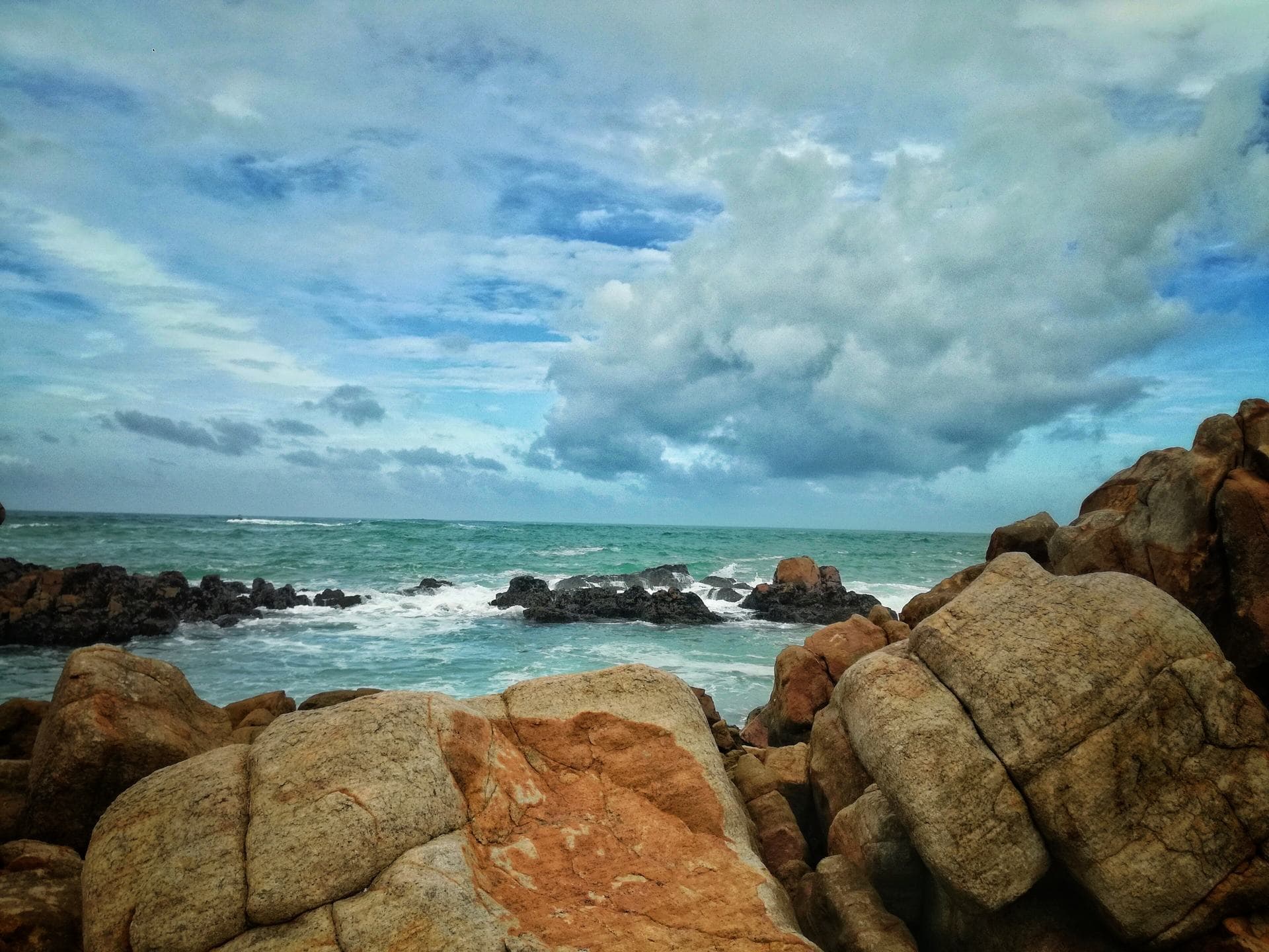 Rocks and surf on a quiet beach near Mirissa